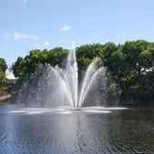 Cascade Libra Pond Fountain With Trees  Under The Clear Blue Sky