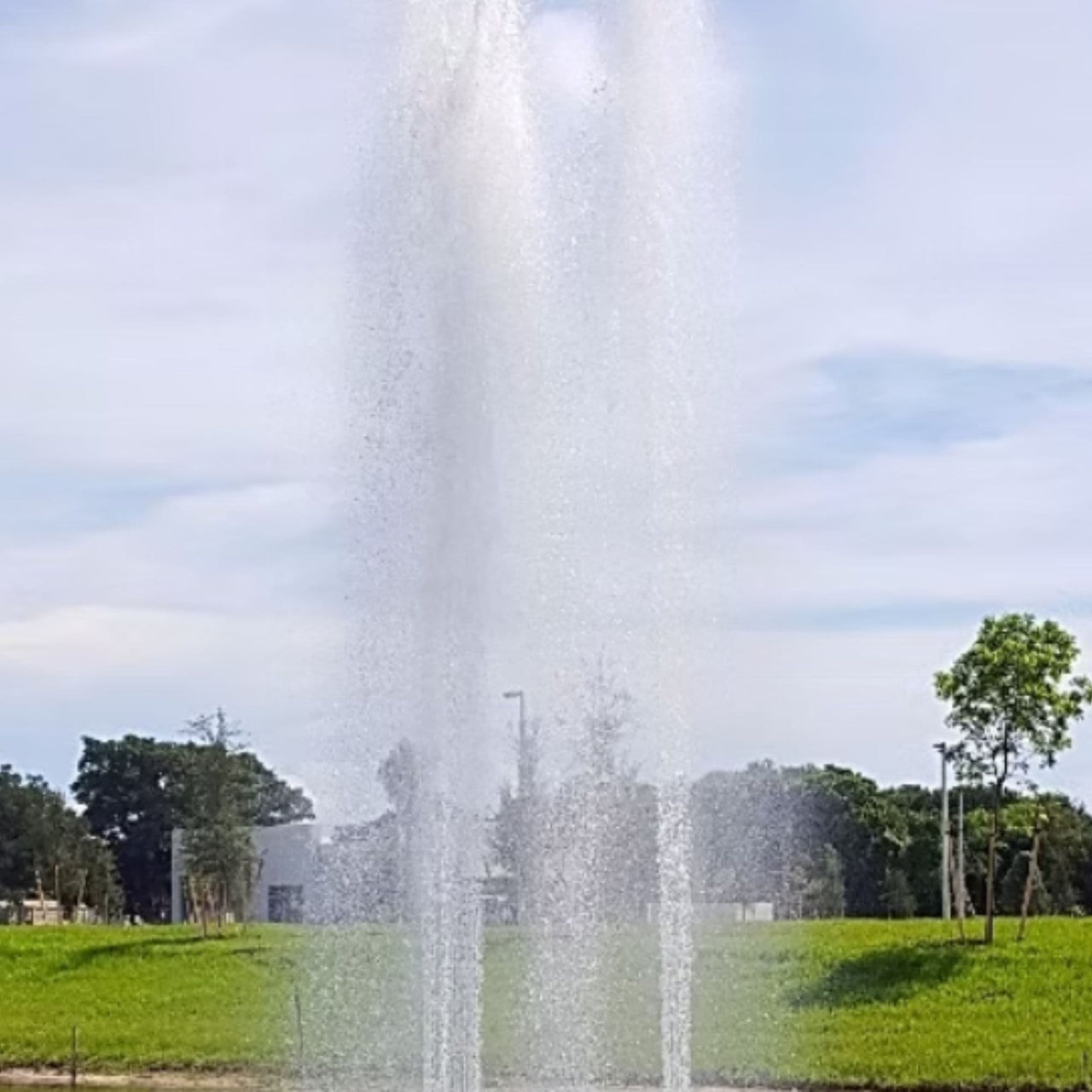 Cascade Orion Fountain Close-up With Trees Under Clear Sky