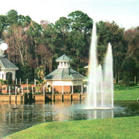 Thumbnail for Cascade Orion Pond Fountain With Trees And Small Buildings  In The Background