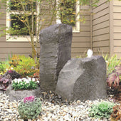 Cascade Outdoor Double Fountain With House In The Back And Surrounded By Plants