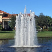 Cascade Pisces Pond Fountain With Big House And Trees In The Background