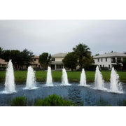 Cascade Single Jet Pond Fountain With Big Houses And Trees In The Background