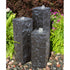 Thumbnail for Chiseled Black Basalt Column Outdoor Fountain With Different Plants In The Background