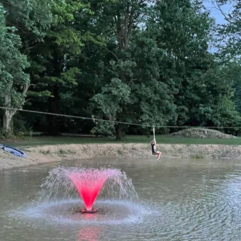 Color Changing Fountain LED Lights Benefits With Bright Pink Lights In Green Scenery Outdoor Pond During Daytime