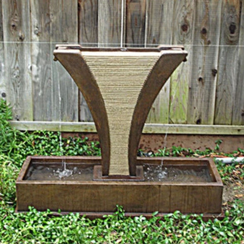 Diesse Fountain with Side Spillways With Wooden Fence Background