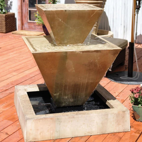 Double Oblique Garden Water Fountain By Gist With Flower Beside And White Wall In The Background