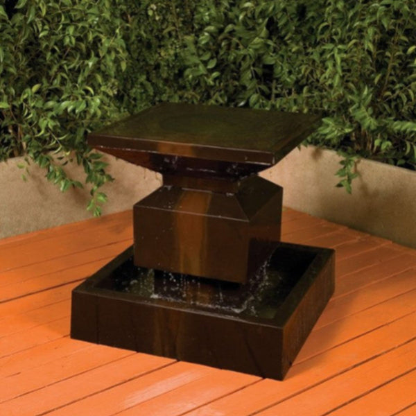 Elegant Classic Alaster Water Feature With Plants In The Background