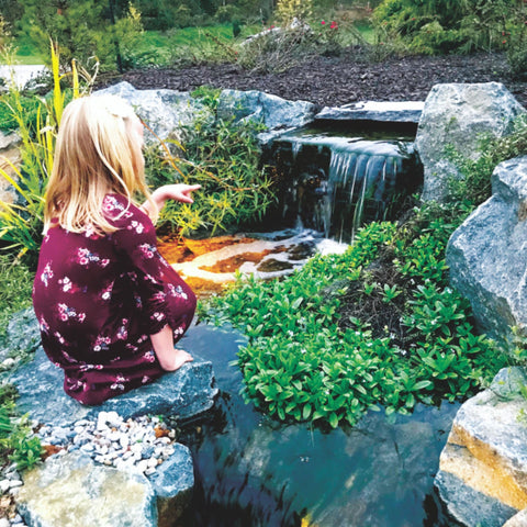 Elite Pondless Waterfall Kit By Blue Thumb Girl Sitting Beside Small Garden Waterfall