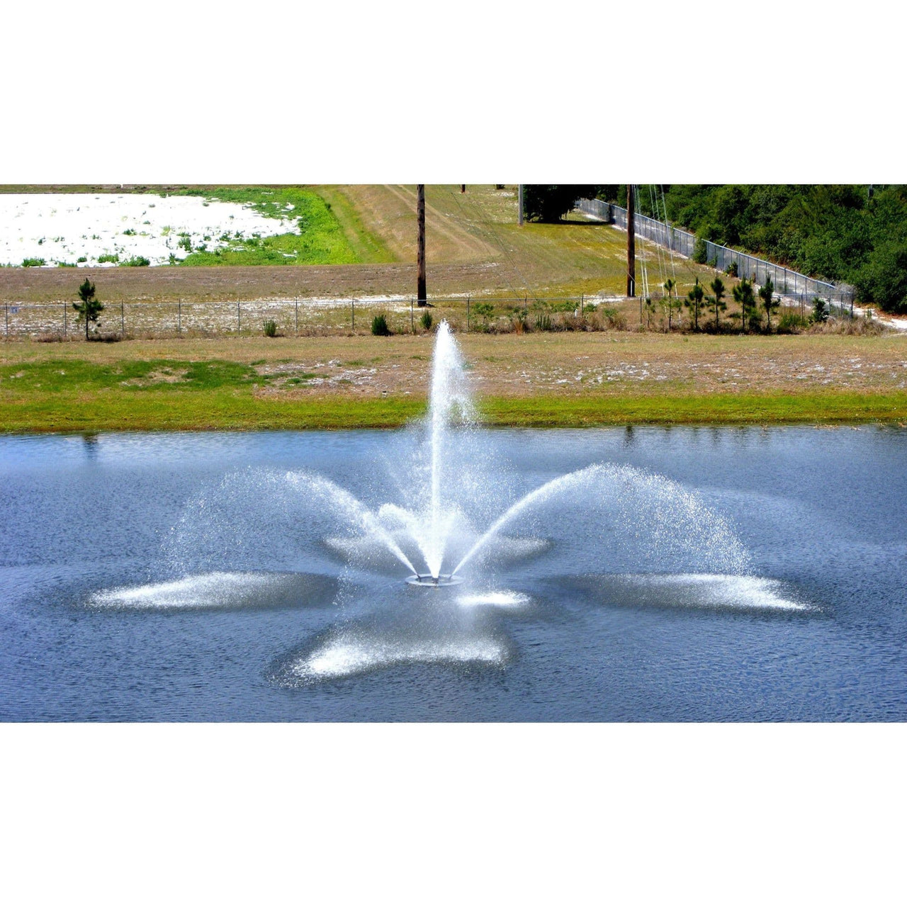 FanJet Pond Fountain With Snow And A Field Behind