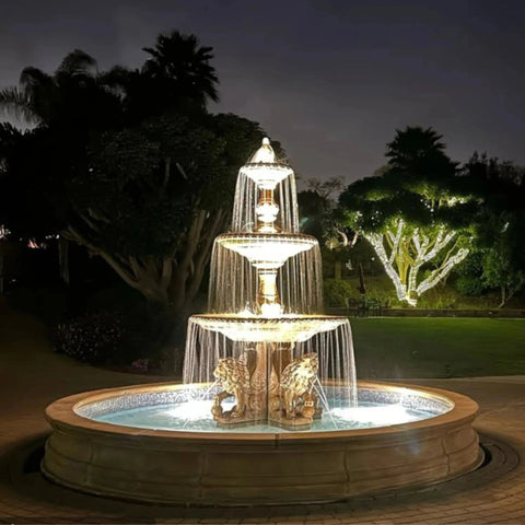 Fiore Stone Four Seasons Fountain with Lion Base Pedestals and 12 Pond With Garden Lightings And Trees In The Background
