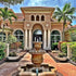 Thumbnail for Fiore Stone Scallop Urn Outdoor Fountain with Quatrefoil Basin With Huge House In The Background