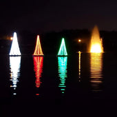 Floating Christmas Tree With 3 Colors White Red & Green With A Fountain In The Background