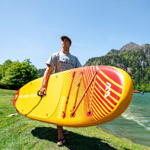 Fusion Stand up Paddle Board with Man Carrying It