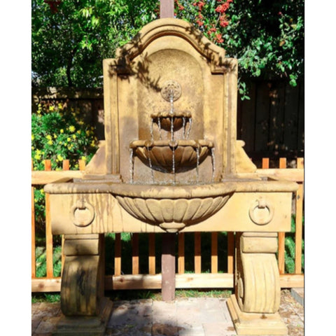 Giannini Garden Anduze Wall Fountain Tall With Wood Fence And Green Plants In The Background