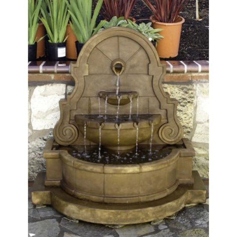 Giannini Garden Liguria Wall Water Fountain with Step and Concrete Spout With Plants In The Background
