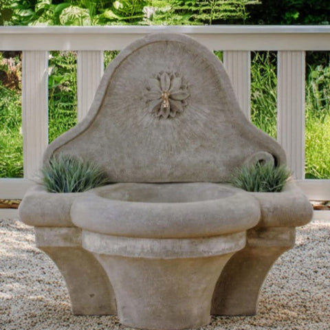 Giannini Garden Provence Wall Fountain For Spout With White Railing And Greenery In The Background