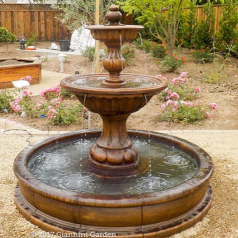 Giannini Garden Sienna Pond Fountain at the Backyard Garden With Flowers And Wooden Fence