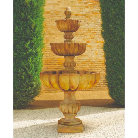 Giannini Garden Urbino Grande Three Tier Fountain With Tall Green Hedges And Brick Wall In The Background