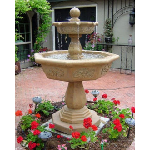 Giannini Garden Uva Two Tier Outdoor Water Fountain Surrounded By Red Flowers With a House In The Background