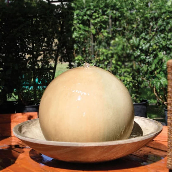 Gist Ball And Wok Outdoor Water Fountain With  Plants In The Background