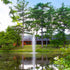 Thumbnail for Gusher Nozzle Beside A Rustic Lodge And Surrounded By Green Trees