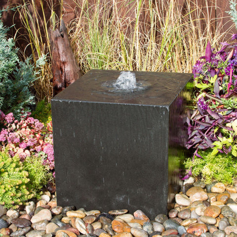 Heiho Basalt Stone Outdoor Fountain Surrounded By Flowers