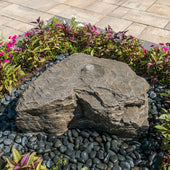 Horseshoe Falls Stone Outdoor Fountain Surrounded By Plants And Flowers