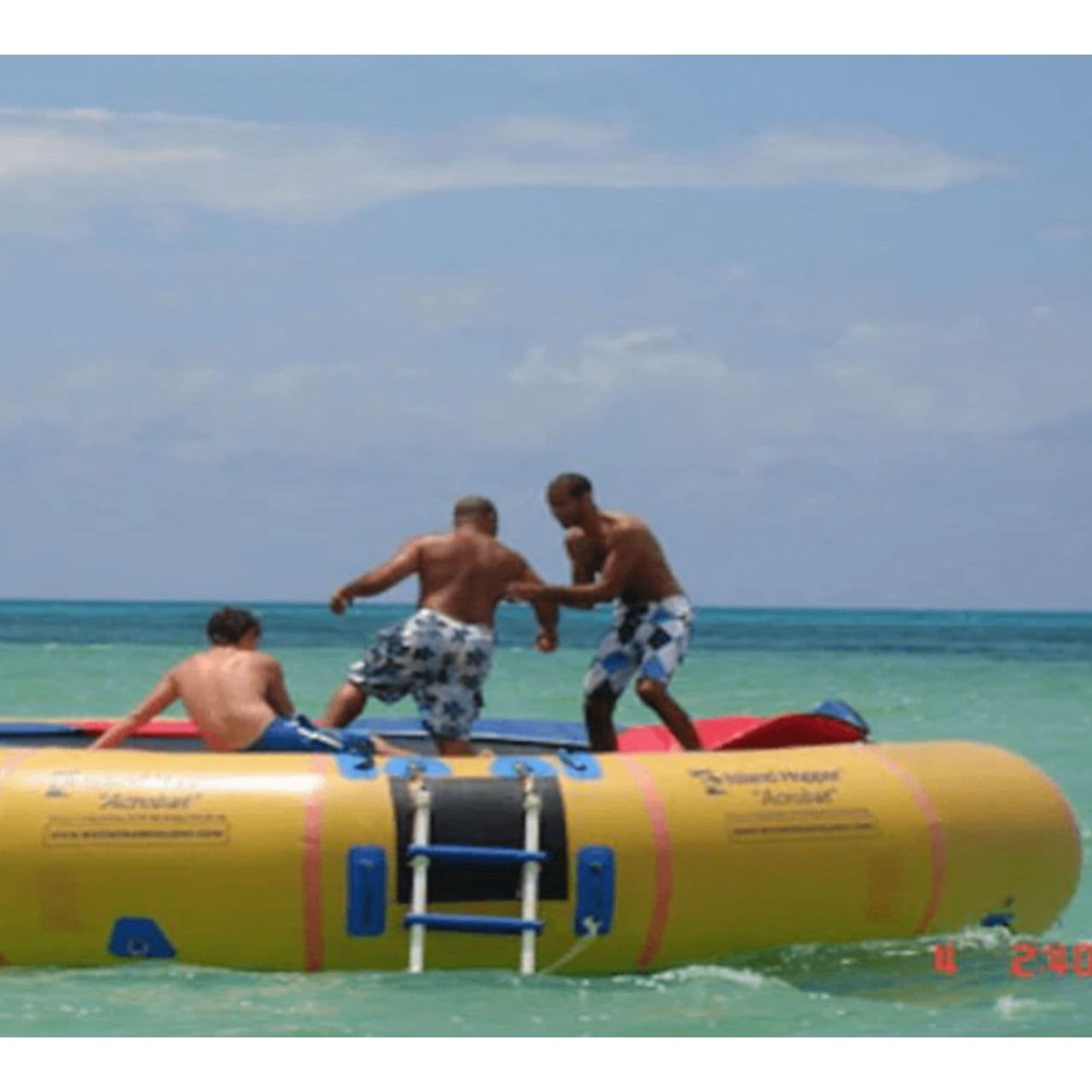 Island 20 Acrobat Water Trampoline With Three Men Playing in Ocean