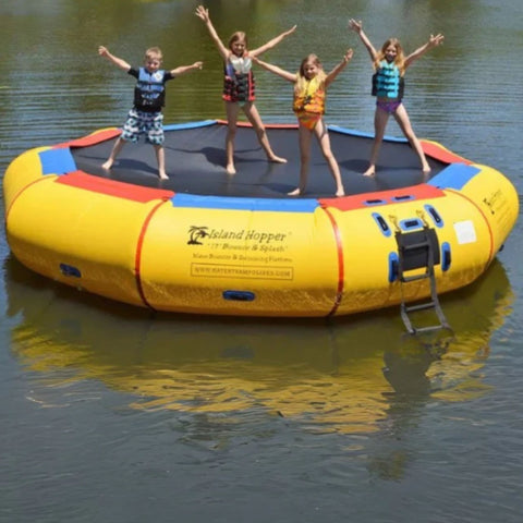 Island Hopper 17 Bounce n Splash Water Bouncer Floating In Calm Lake With Four Kids Raising Their Hands