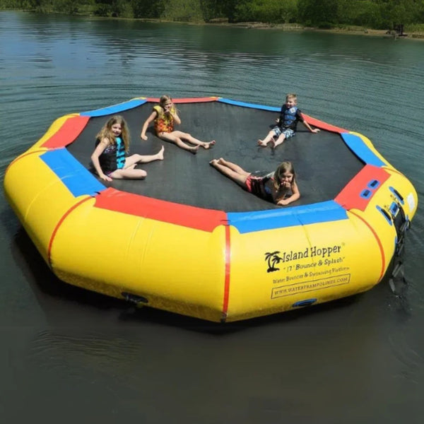 Island Hopper 17 Bounce n Splash Water Bouncer Floating In Calm Water With Four Kids Resting