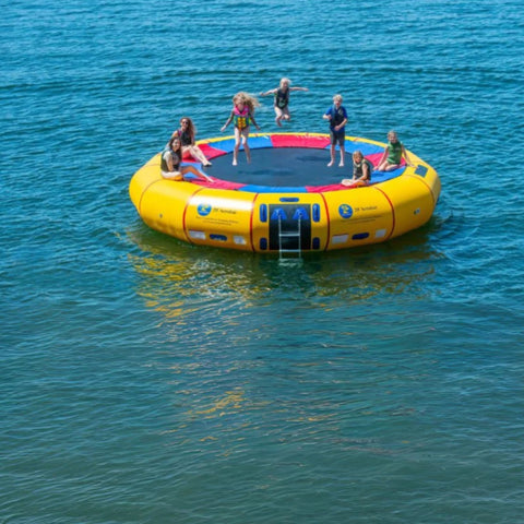 Island Hopper 20 Acrobat Water Trampoline Floating On The Blue Calm Waters With Three Kids Are Jumping While The Other Three Are Sitting With Their Mother