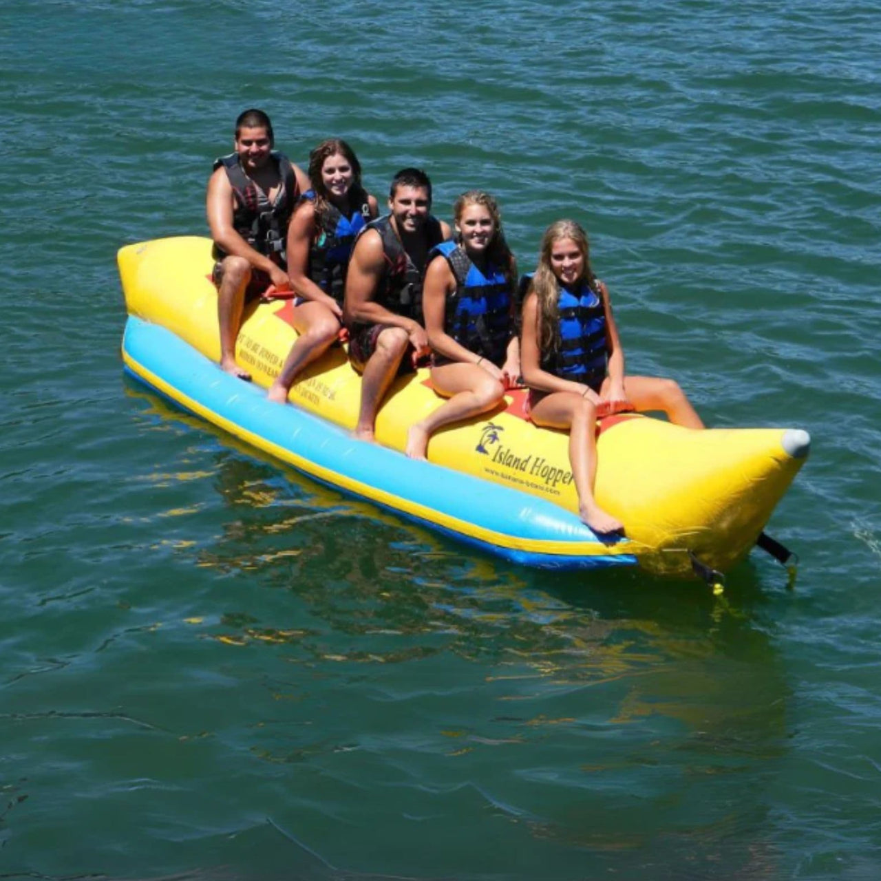 Island Hopper 5 Person Towable Banana Boat  With Five People Smiling On A Fun Ride