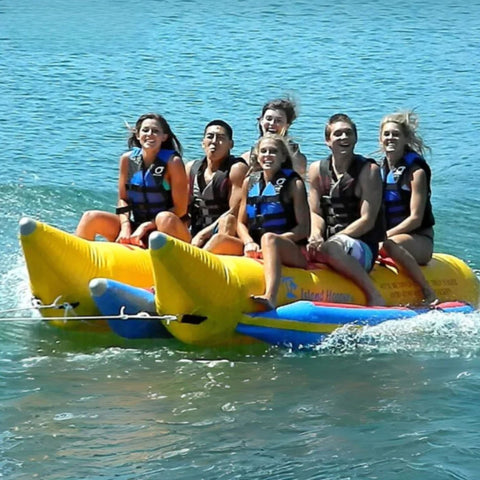 Island Hopper Elite Class 6 Person Side By Side Banana Boat With Six People Laughing While Riding On Waves