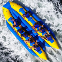 Thumbnail for Island Hopper Elite Class Banana Buss 14 Person Banana Boat Overhead View Of Kids Banana Boating On The Waves