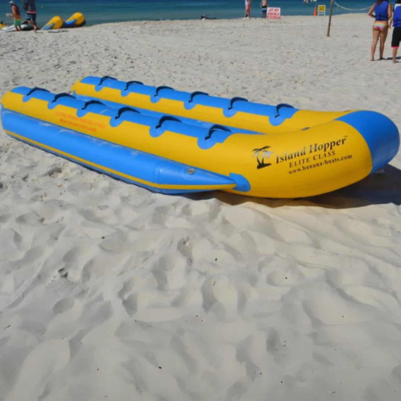 Island Hopper Elite Class Banana Taxi 12 Person Banana Boat Resting On White Sand Beach
