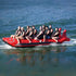 Thumbnail for Island Hopper Elite Class Red Shark 10 Person Banana Boat With Smiling Group Enjoying The Ride On The Deep Ocean