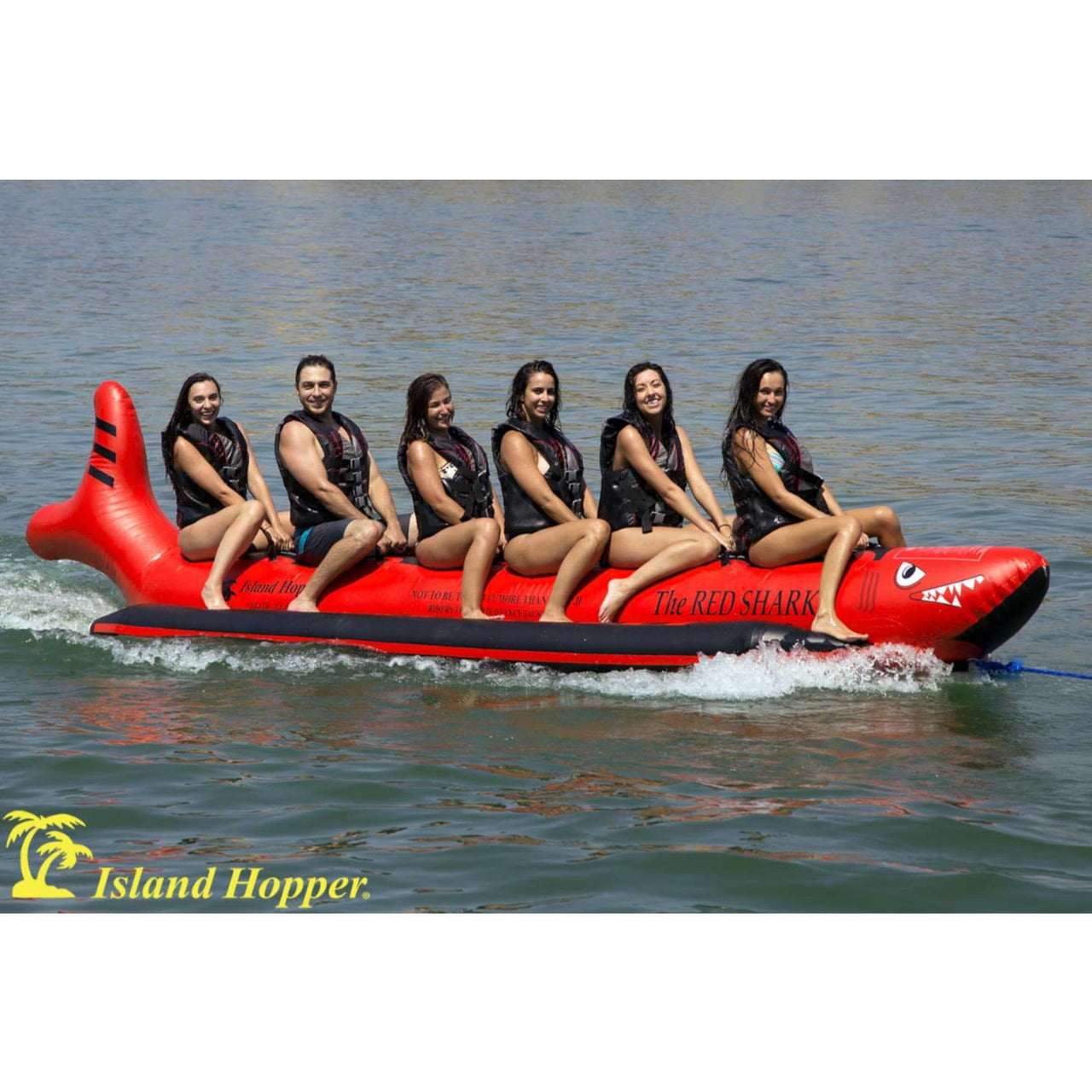 Island Hopper Elite Class Red Shark 6 Person Banana Boat With Six People Enjoying The Ride On The Deep Ocean