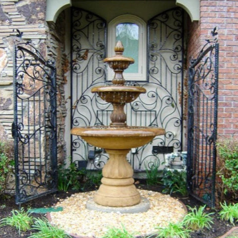 Isola Three Tier Fountain With Black Gate And A House In The Background