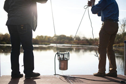 Kasco De-Icer Unit Being Held By Two People On A Sling