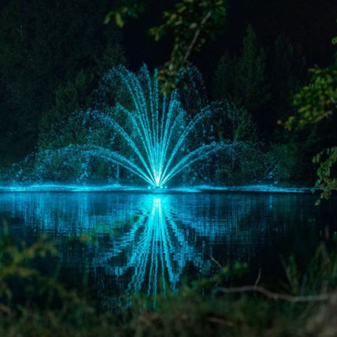Kasco Mighty Oak Premium Fountain Nozzle Beneath A Dark Night Sky With Vibrant Blue Reflections On Calm Water
