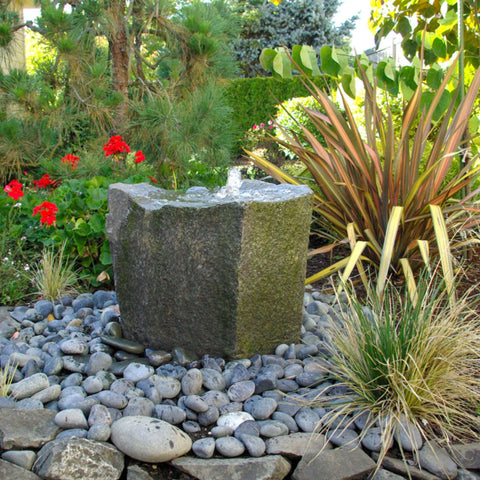 Klamath Basin Stone Outdoor Fountain With Plants And Flowers In The Background