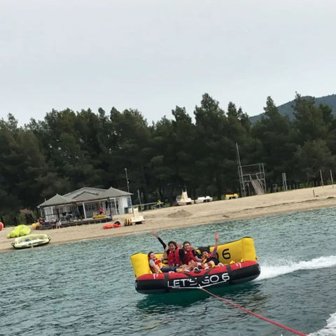 Lets Go 6 Towable Four Riders Enjoying The Ride With Trees In The Background