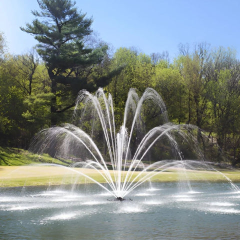 Mighty Oak Premium Fountain Nozzle Beneath A Clear Blue Sky And Surrounded By Lush Green Trees