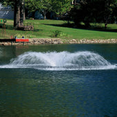 OWS Air-O-Lator Aquarian Pro Surface Aerator On The Water With Trees In The Background