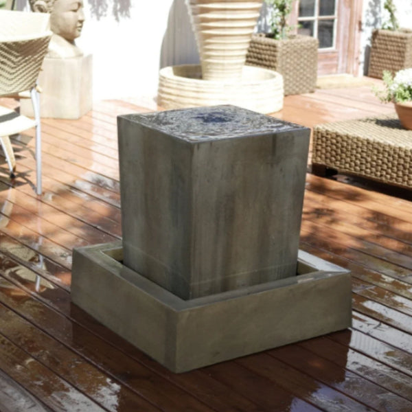 Obtuse Garden Water Fountain By Gist With Planters And Buddha Face In The Background