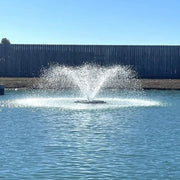 Outdoor Water Solutions 1/2 HP Aerify Electric Pond Aerator Fountain On The Water With A Fence In The Background