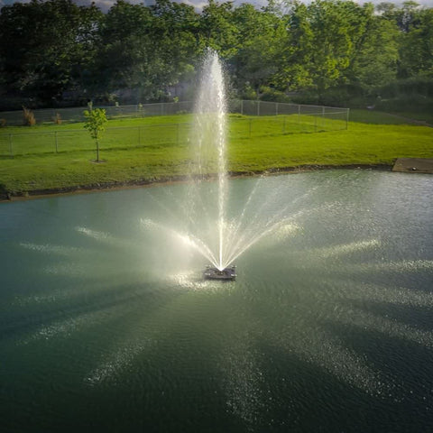 Outdoor Water Solutions 1/2 HP Palatial Electric Pond Fountain On The Water With Trees In The Background