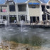 Thumbnail for Outdoor Water Solutions EcoSeries Floating Pond Fountain 2 Units On The Water With A Building In The Background