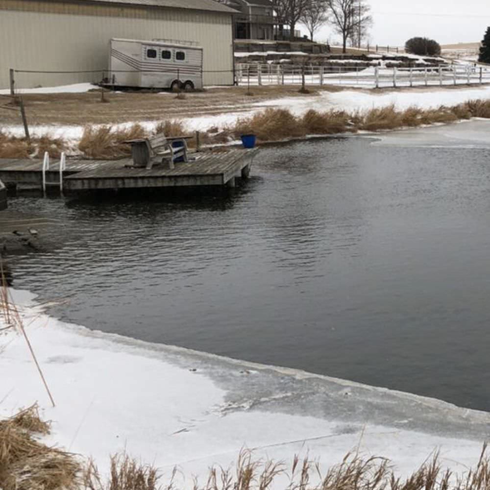 Outdoor Water Solutions Ice-Away Pond De-Icer On The Water Near A Small Pier