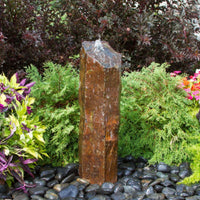 Thumbnail for Outdoor Basalt Column Fountain Surrounded By Shrubs, Colorful Plants And Flowers